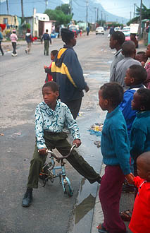 Cape Town Townships street scene with kids and bicycle